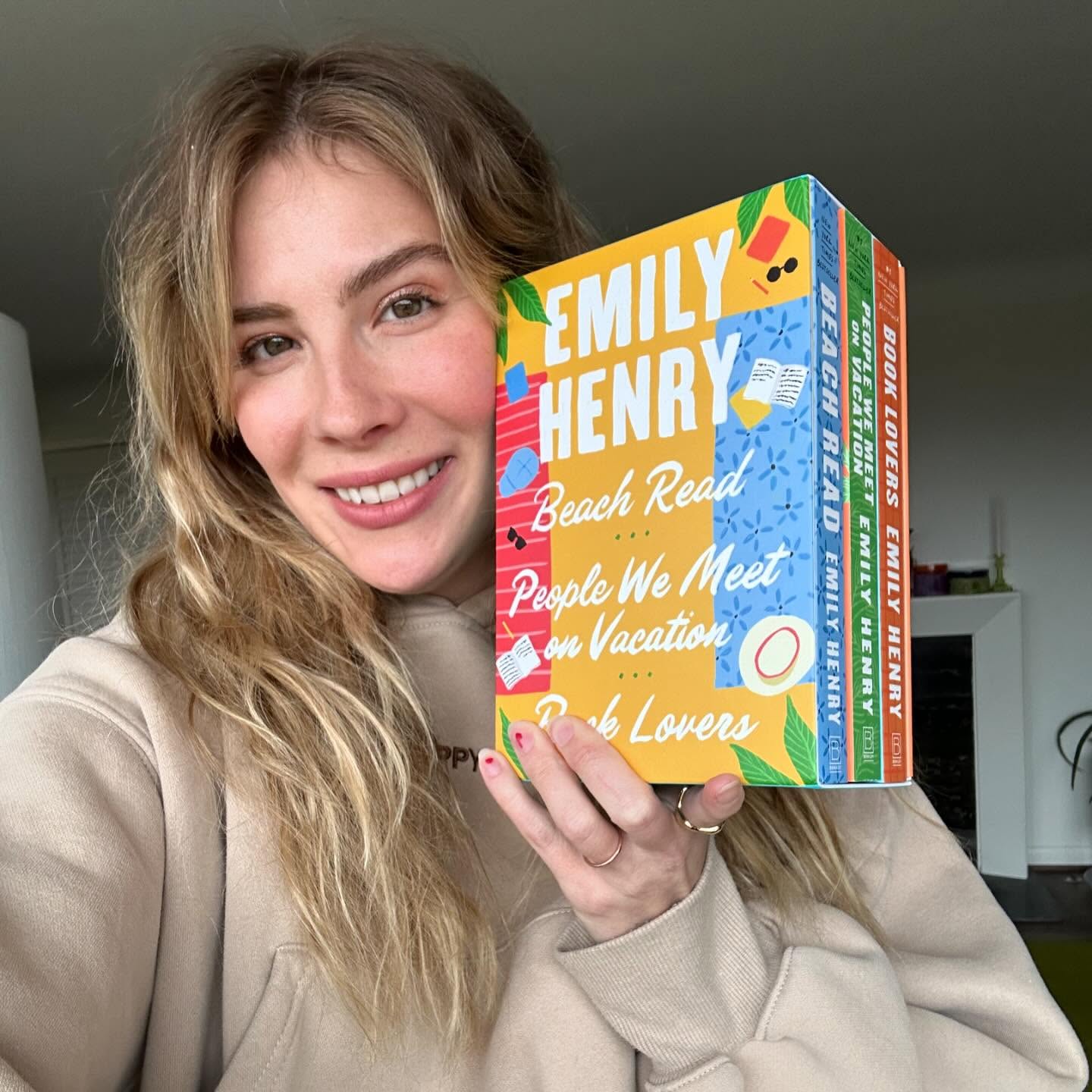 Emily Henry holding books